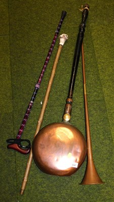 Lot 2247 - A copper hunting horn, together with a warming...