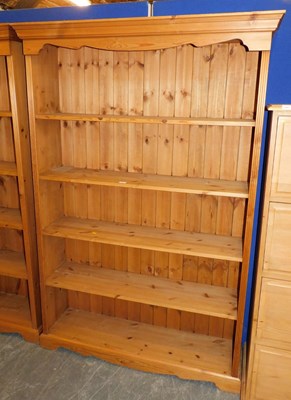 Lot 1006 - A pine open bookcase, the top with a moulded...