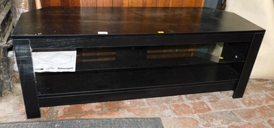 Lot 1030 - A black ash television stand, with glass shelf...