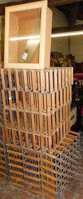 Lot 1032 - Seven wine bottle racks, together with a...