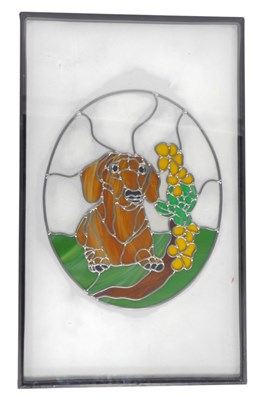 Lot 86 - A stained glass panel, of oval form, depicting...