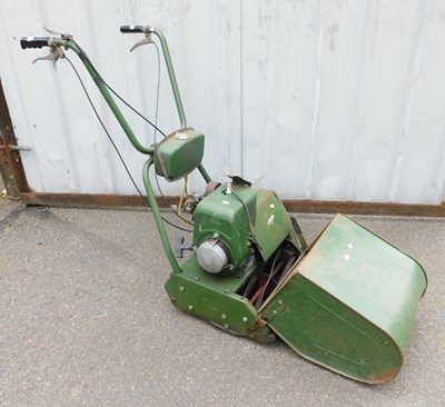 Lot 1117 - A vintage green petrol lawn mower.