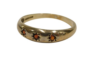 Lot 149 - A 9ct gold garnet three stone dress ring, set...