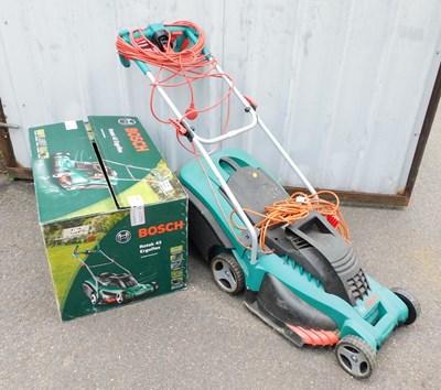 Lot 1141 - A Bosch electric lawn mower. Buyer Note:...