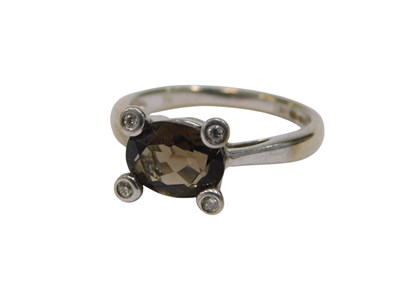 Lot 124 - A 9ct white gold dress ring, set with oval...