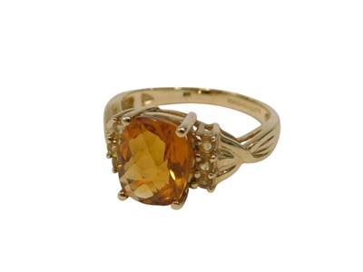 Lot 126 - A 9ct gold citrine and CZ set dress ring, the...