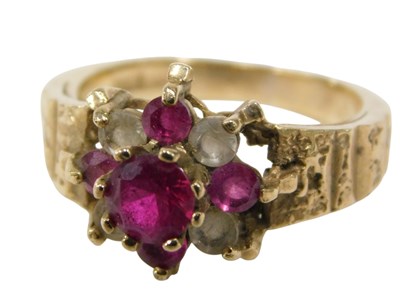 Lot 136 - A floral cluster ring, the layered floral...