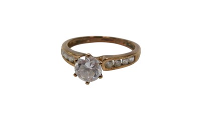 Lot 143 - A 9ct gold CZ dress ring, the raised central...