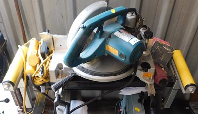 Lot 613 - A Makita LS1040 mitre saw, with stand, serial...