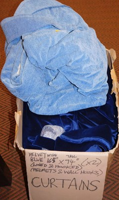 Lot 1023 - A pair of lined dark blue velvet curtains,...