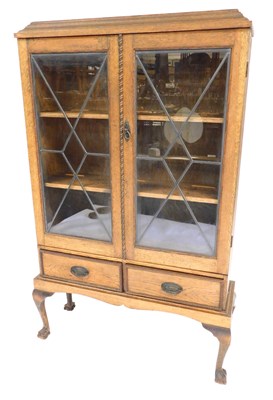 Lot 684 - An early 20thC oak display cabinet, with an...