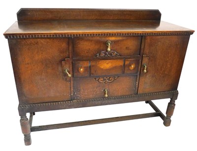 Lot 713 - An early 20thC oak sideboard, with three...