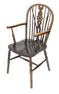 Lot 731 - An oak and elm wheelback Windsor chair, with a...