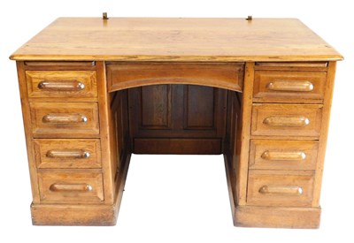 Lot 660 - An early 20thC oak twin pedestal desk, with a...
