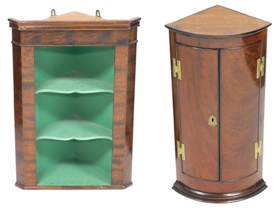 Lot 663 - A George III bow front mahogany hanging corner...