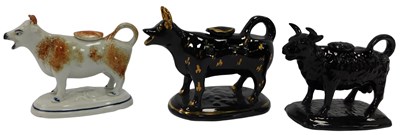 Lot 61 - Three late 19thC pottery cow creamers,...