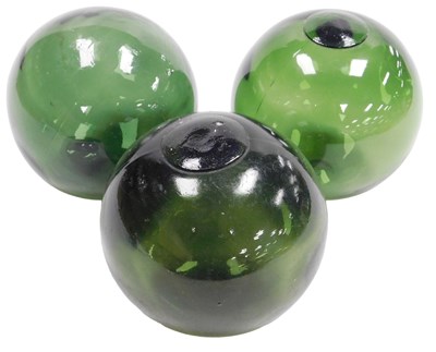 Lot 47 - Three green glass floats, or witch's balls.