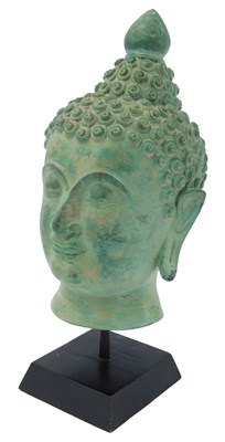 Lot 127 - A green patinated metal bust of Buddha, on an...