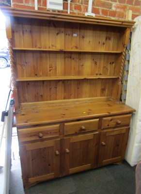Lot 1001 - A pine dresser, with plate rack over base unit...