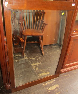 Lot 1067 - A rectangular wooden framed mirror, 113cm x 78cm.