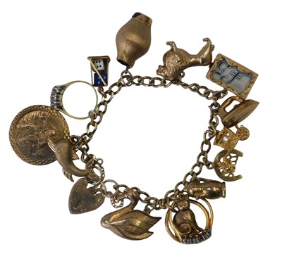 Lot 10 - A 9ct gold flattened curb link charm bracelet...