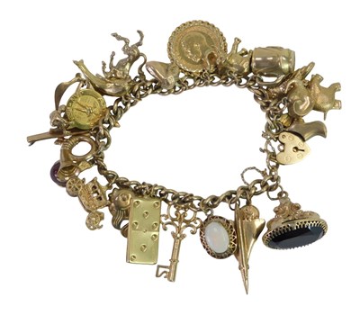 Lot 9 - A 9ct gold curb link charm bracelet, the curb...