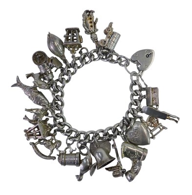 Lot 358 - A silver charm bracelet, the curb link...