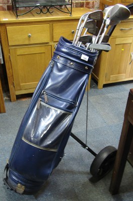 Lot 1034 - A golf bag and contents of clubs, drivers,...