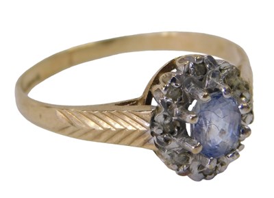 Lot 403 - A 9ct gold cluster ring, set with an oval cut...