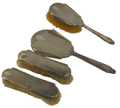 Lot 434 - A George V silver mounted four-piece dressing...