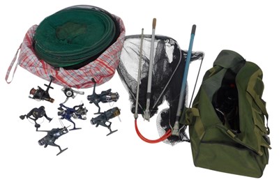 Lot 215 - A fishing holdall containing fixed spool reels,...