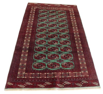 Lot 745 - A Bokhara pale green and red ground rug, the...