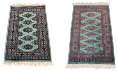 Lot 750 - A near pair of Bokhara pale green ground...
