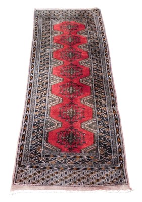 Lot 757 - A Bokhara red ground runner, the central field...