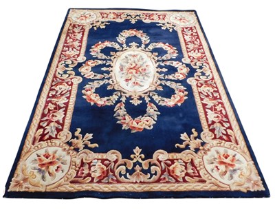 Lot 760 - A Kaz Chinese blue ground rug, decorated with...