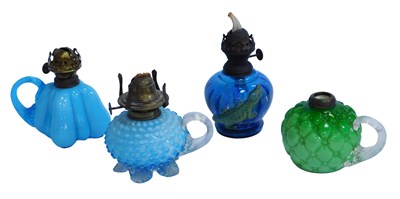 Lot 527 - Four finger oil lamps, comprising two milk...