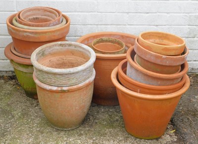 Lot 554 - A group of terracotta planters, each of...