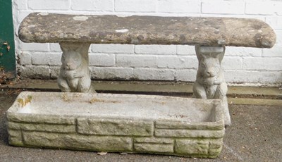 Lot 566 - A composition stone garden bench, the...