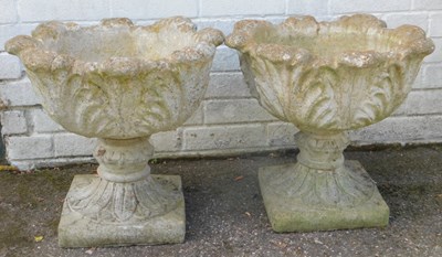 Lot 569 - A pair of composition stone garden planters,...