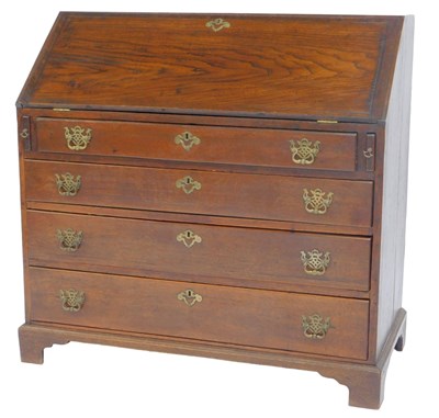 Lot 605 - A George III oak bureau, the fall enclosing...