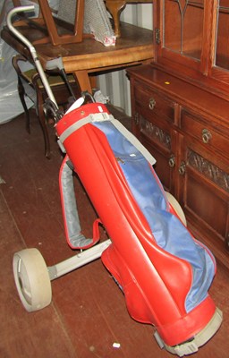 Lot 1097 - A Titleist golf trolley and golf clubs,...