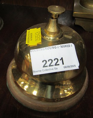 Lot 2221 - A brass bell on wooden stand.
