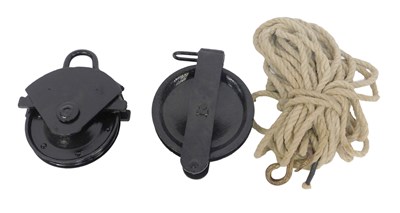 Lot 616 - Two black painted cast iron pulley...