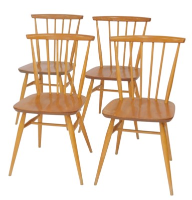 Lot 633 - A set of four Ercol light elm dining...