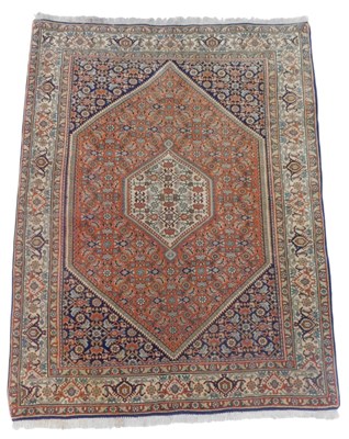 Lot 697 - A Bijar Persian red ground rug, central...