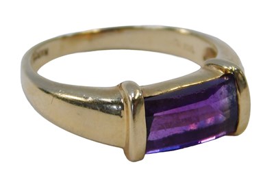 Lot 378A - An amethyst dress ring, the rectangular cut...