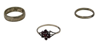 Lot 345 - Three silver dress rings, comprising a garnet...