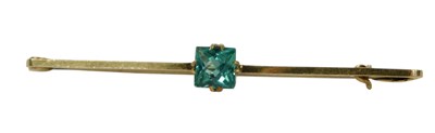 Lot 313 - A bar brooch, set with square cut bluey green...