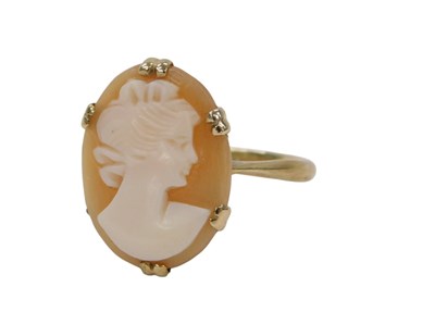 Lot 324 - A cameo dress ring, the oval cameo in claw...