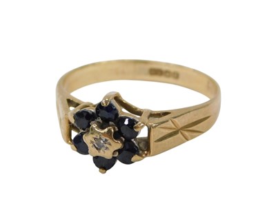 Lot 114 - A 9ct gold floral cluster ring, centre set...